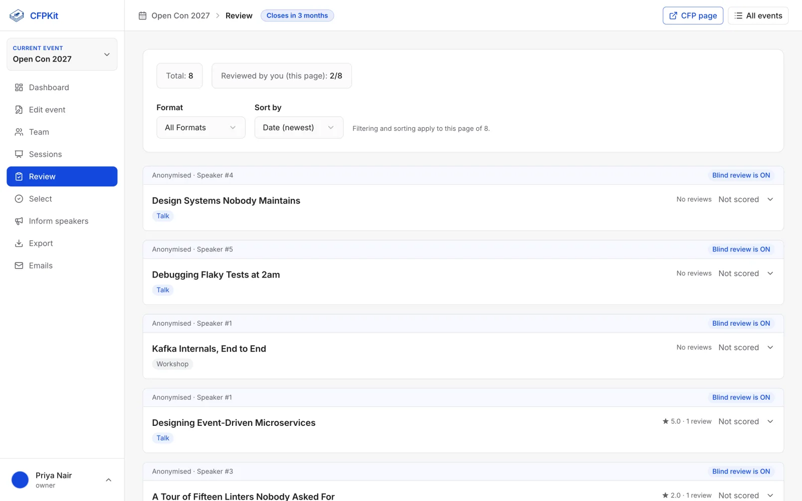 Blind review screen listing proposals by title and abstract with scoring controls